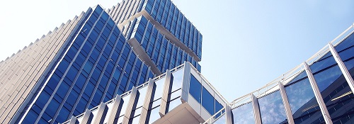 An image of some glass financial buildings looming into the sky